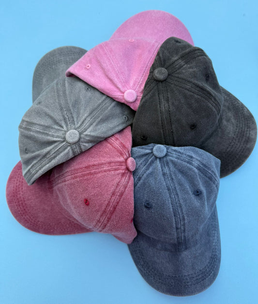 Five baseball caps in Pink, Black, Gray, Maroon and Blue.