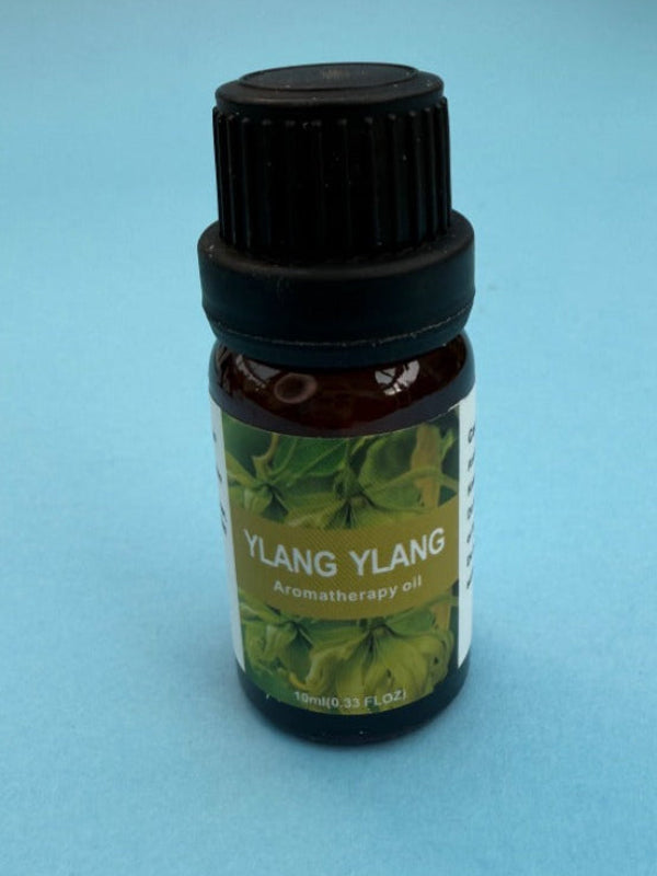 Ylang Ylang aromatherapy oil bottle on a light blue background